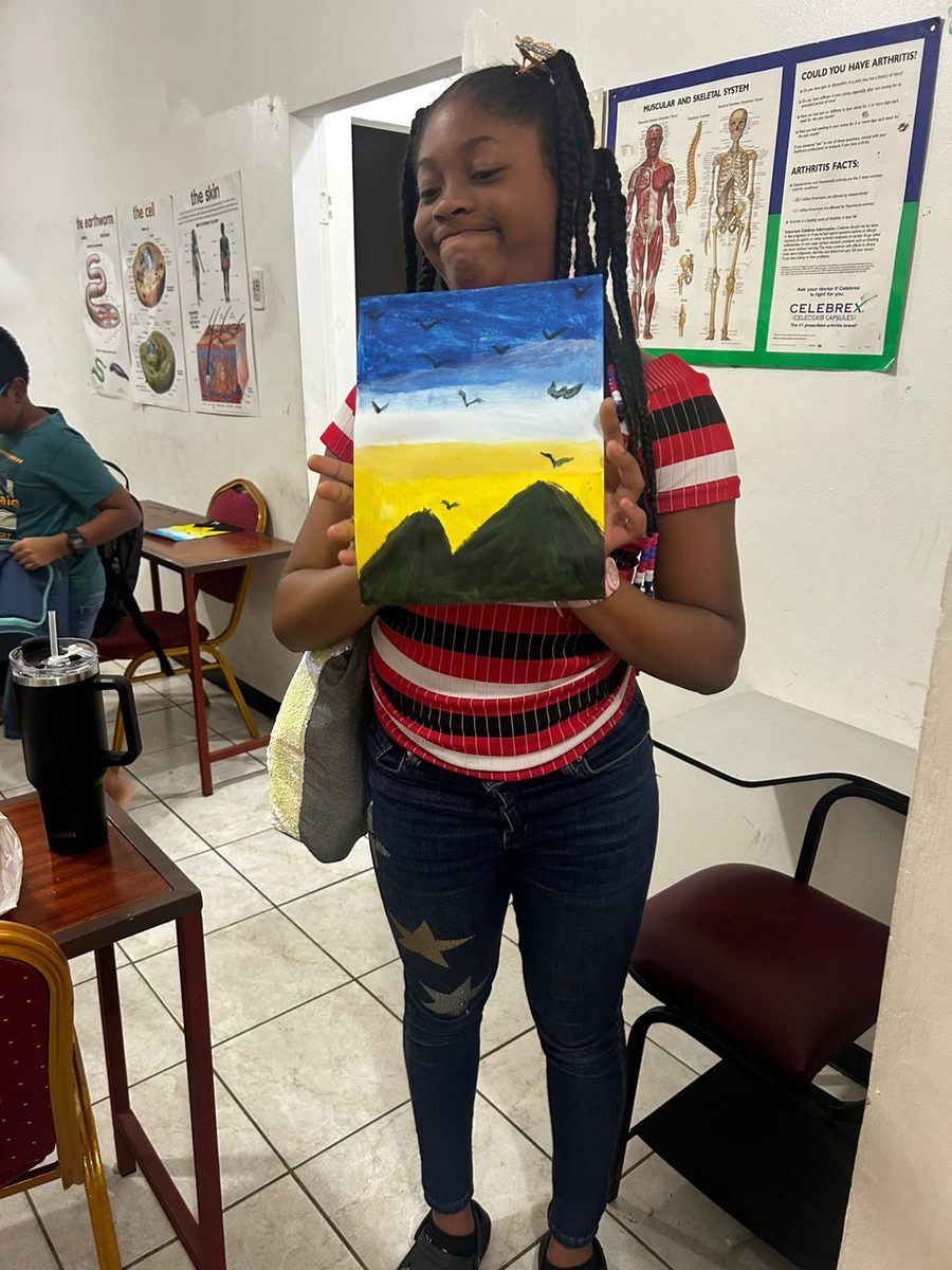 Student showing her completed artwork